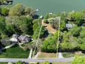 Aerial view of lot with lake access surrounded by mature trees at 1395 Roundstone Rd, Sherrills Ford, NC 28673