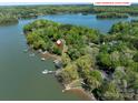 Aerial view of a wooded lakeside lot at 1395 Roundstone Rd, Sherrills Ford, NC 28673