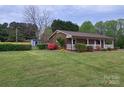Charming brick home featuring a lush lawn, tidy landscaping, and a welcoming front porch at 1663 Smyre Farm Rd # 5, Newton, NC 28658