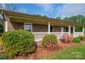 Charming brick home with a covered front porch and colorful landscaping at 1663 Smyre Farm Rd # 5, Newton, NC 28658