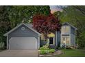 Charming home with a two-car garage, beautiful landscaping, and a striking red maple tree in the front yard at 181 Glynwater Dr, Mooresville, NC 28117