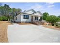 Inviting home with a new concrete driveway and well-manicured landscaping at 203 E 27Th St, Kannapolis, NC 28083