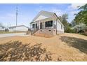 A cozy home featuring a covered porch and fresh, newly laid lawn at 203 E 27Th St, Kannapolis, NC 28083