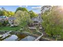 Expansive aerial view showcasing the home's lakefront location and manicured landscaping at 20428 Island Forest Dr, Cornelius, NC 28031