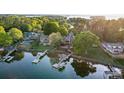 Stunning aerial view of the waterfront property with lush landscaping and private dock at 20428 Island Forest Dr, Cornelius, NC 28031