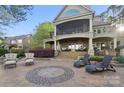 A beautiful backyard patio with outdoor furniture and lush landscaping creates a relaxing atmosphere at 20428 Island Forest Dr, Cornelius, NC 28031