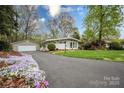 Attractive home features a well-maintained driveway with lovely landscaping and a detached garage at 2239 Wensley Dr, Charlotte, NC 28210