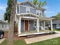 Attractive two-story house with a cozy front porch and well-maintained landscaping at 2315 Dundeen St, Charlotte, NC 28216