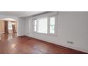 Spacious living room featuring hardwood floors, natural light, and an open archway at 2326 Armstrong Cir, Gastonia, NC 28054