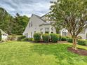 Well-manicured lawn and lush landscaping surround this lovely home, offering great curb appeal at 2516 Middlebridge Ln, Charlotte, NC 28270