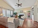 Bright living room featuring a fireplace, built-in shelving, and a ceiling fan at 2516 Middlebridge Ln, Charlotte, NC 28270