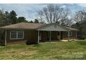 Charming one-story brick home featuring a covered front porch and well-maintained lawn at 3253 Centergrove Rd, Kannapolis, NC 28083