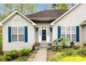 Close up exterior view of the home highlighting the front entrance, blue shutters, and manicured landscaping at 3505 Mayspring Pl, Charlotte, NC 28269