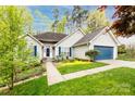 Inviting exterior view featuring siding, manicured lawn, and vibrant landscaping with colorful flowers and shrubs at 3505 Mayspring Pl, Charlotte, NC 28269