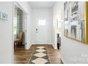 Bright hallway with wood floors, a patterned rug, and an elegant painting on the white wall at 4610 Harris Elliot Rd, Lincolnton, NC 28092