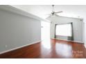 Bright living room features a ceiling fan, hardwood floors, and large window at 5015 Drake Pond Ln, Rock Hill, SC 29732