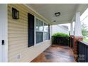 Cozy covered porch with outdoor lighting and brick accents at 5015 Drake Pond Ln, Rock Hill, SC 29732
