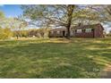 Lovely brick home with a large front yard and mature trees providing ample shade at 70 Liberty Church Rd, Taylorsville, NC 28681