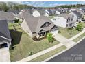 Aerial view of a residential property showcasing its well-manicured lawn and neighborhood at 7633 Tanglewood Way, Denver, NC 28037