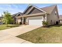 View of home's exterior with a two-car garage and well-maintained lawn at 7633 Tanglewood Way, Denver, NC 28037