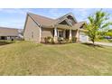 The exterior of this house is well-maintained with healthy lawn and landscaping at 7633 Tanglewood Way, Denver, NC 28037