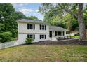 Charming two-story home boasts a well-manicured lawn, a white picket fence and beautiful landscaping at 8025 Cliffside Dr, Charlotte, NC 28270