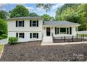 Traditional two-story home with black shutters, freshly painted and landscaping in front yard at 8025 Cliffside Dr, Charlotte, NC 28270