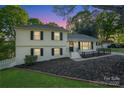 Charming two-story home featuring a well-manicured lawn and inviting front porch at 8025 Cliffside Dr, Charlotte, NC 28270