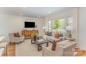 Comfortable living room featuring large windows, neutral tones, and a stylish furniture arrangement at 8025 Cliffside Dr, Charlotte, NC 28270