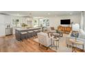 Open-concept living room with a kitchen island and sleek modern furniture at 8025 Cliffside Dr, Charlotte, NC 28270