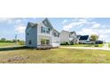 A well-manicured lawn surrounds this two-story home with gray siding and an attached garage at 101 Glencroft Dr, Wingate, NC 28174