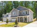 Attractive two-story home with gray siding, a two-car garage, and a well-maintained front lawn at 1032 Dooley Dr, Charlotte, NC 28227