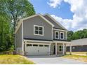 Beautiful two-story home boasts a two-car garage, inviting entrance, and lovely curb appeal at 1032 Dooley Dr, Charlotte, NC 28227