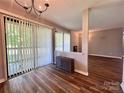 Bright dining area features wood floors, sliding glass doors, and easy access to the living room at 11015 Harrowfield Rd, Charlotte, NC 28226
