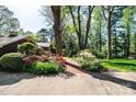 Home exterior features a red brick path, mature trees, and vibrant azaleas at 1213 10Th Street Nw Ln # 3, Hickory, NC 28601