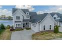 Beautiful gray two-story home featuring an attached two-car garage and well-manicured landscaping at 139 Little Indian Loop, Mooresville, NC 28117