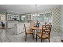 Charming kitchen with white cabinetry, tiled countertops, and a cozy breakfast nook with a view at 1676 Partridge Cir, Lancaster, SC 29720