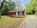 Exterior of cozy brick house with a convenient carport and ample parking space at 1780 Short St, Mount Pleasant, NC 28124