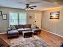 Comfortable living room with a plush sectional sofa, ceiling fan, and ample natural light at 1780 Short St, Mount Pleasant, NC 28124