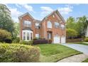 Beautiful brick home with a well-maintained lawn, lovely landscaping, and a two-car attached garage at 1801 Briarcrest Nw Dr, Charlotte, NC 28269