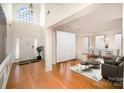 Bright foyer boasts a soaring window above the entry and gleaming hardwood floors that add warmth and character at 1801 Briarcrest Nw Dr, Charlotte, NC 28269