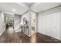 Inviting foyer with wood floors, staircase, console table, mirror, closet and view to living space at 181 Riverview Ter, Clover, SC 29710