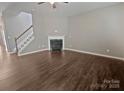 Open living room with a fireplace and hardwood floors, perfect for entertaining at 1907 Caprington Dr, Fort Mill, SC 29707