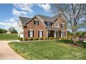Beautiful brick home with lush landscaping and inviting curb appeal at 2003 Ptarmigan Ct, Waxhaw, NC 28173