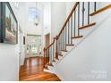 Bright foyer with hardwood floors, staircase, and elegant chandelier at 2003 Ptarmigan Ct, Waxhaw, NC 28173