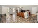A spacious living room with hardwood floors, a ceiling fan, and views of the front yard at 22025 Torrence Chapel Rd, Cornelius, NC 28031