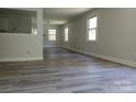The open-concept living room features light-colored walls, new flooring, and lots of natural light at 2822 Royston Rd, Charlotte, NC 28208