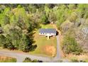 Aerial shot of a charming home with a well-maintained lawn and a driveway leading to the street at 2895 Sweeping Pine Ln, Denver, NC 28037