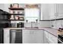 Close-up of a well-organized kitchen featuring stainless steel appliances, granite counters, and ample storage space at 2895 Sweeping Pine Ln, Denver, NC 28037