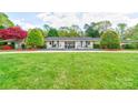 Charming home exterior featuring a well-manicured lawn and inviting front entrance at 316 Country Club Acres None, Shelby, NC 28150